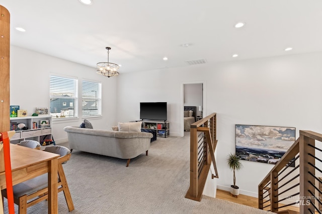 living room featuring baseboards, a chandelier, and recessed lighting