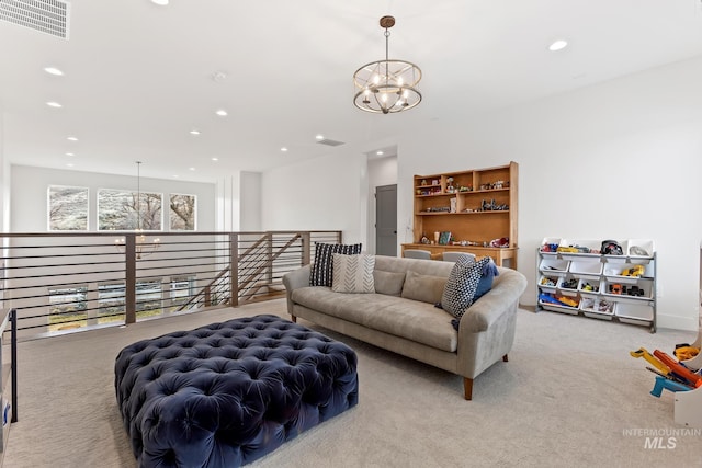 living area with an inviting chandelier, recessed lighting, visible vents, and light colored carpet