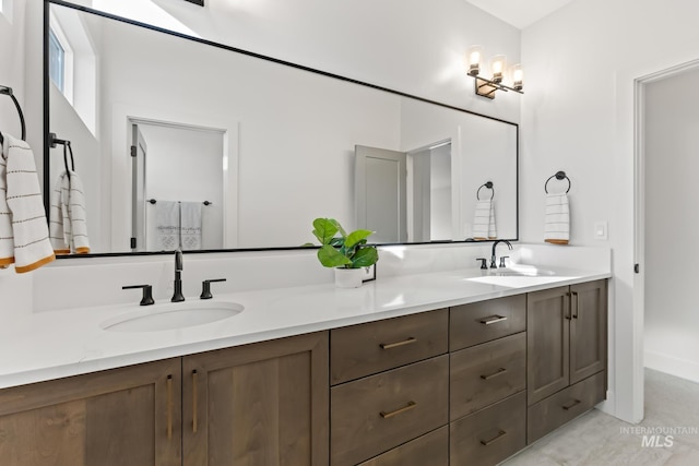 bathroom featuring a sink and double vanity