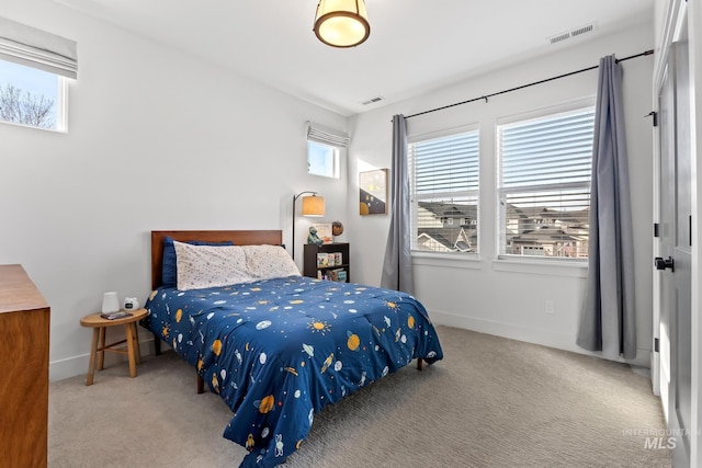 carpeted bedroom featuring visible vents and baseboards