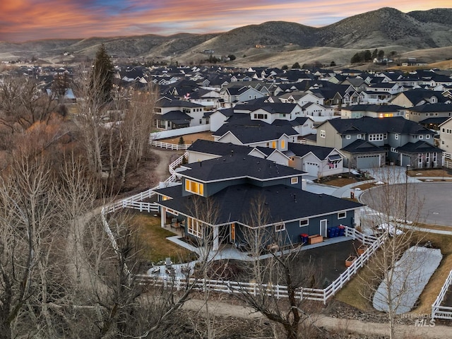 aerial view at dusk with a mountain view and a residential view