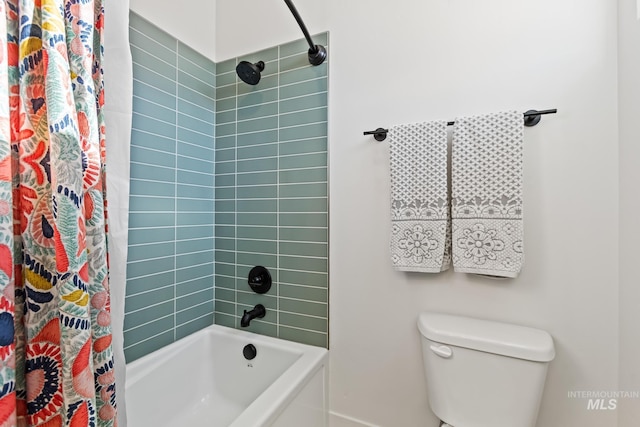 bathroom featuring shower / bath combo with shower curtain and toilet