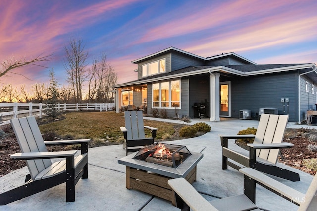 back of house featuring a fire pit, a patio, central AC, and fence