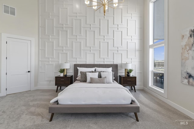 carpeted bedroom featuring a chandelier