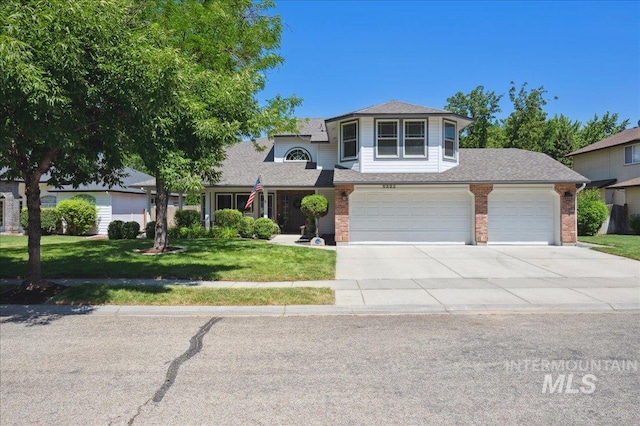 5322 N Papago Pl, Boise, ID 83713 - traditional-style home with driveway, a front lawn, brick siding, and an attached garage