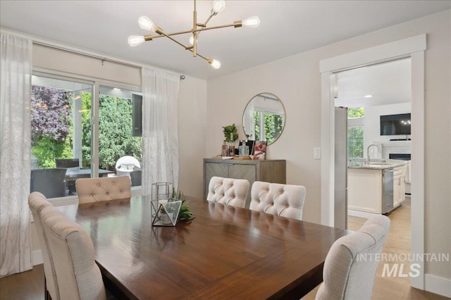 5322 N Papago Pl, Boise, ID 83713 - dining room with a chandelier, plenty of natural light, and light wood finished floors