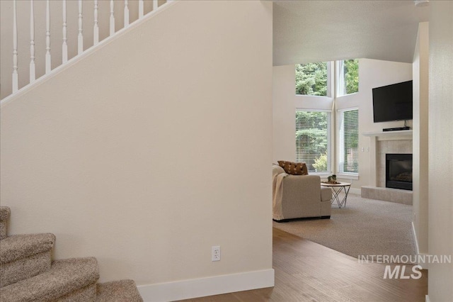 5322 N Papago Pl, Boise, ID 83713 - staircase featuring vaulted ceiling, a tiled fireplace, and wood finished floors
