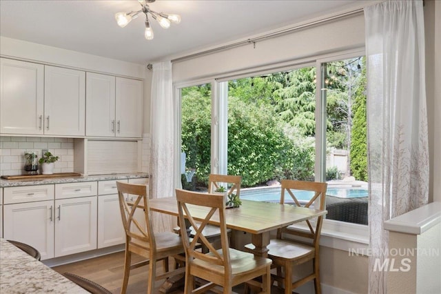 5322 N Papago Pl, Boise, ID 83713 - dining space with light wood-style floors and a chandelier