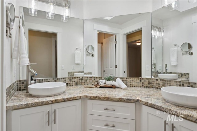 5322 N Papago Pl, Boise, ID 83713 - bathroom featuring decorative backsplash and double vanity
