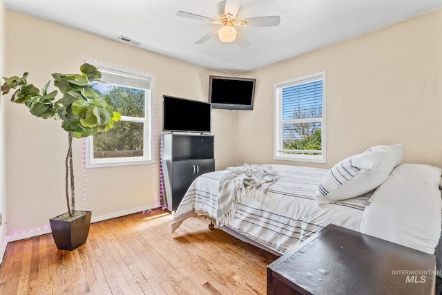 2524 Succor Creek Rd, Homedale, ID 83628 - bedroom with multiple windows, wood finished floors, baseboards, and ceiling fan
