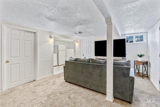 2524 Succor Creek Rd, Homedale, ID 83628 - carpeted living room with a textured ceiling, washer and dryer, a textured wall, and baseboards