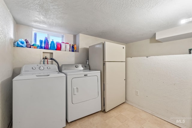 2524 Succor Creek Rd, Homedale, ID 83628 - clothes washing area featuring a textured ceiling, washer and clothes dryer, light flooring, and baseboards