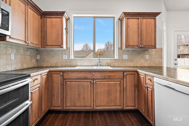 1452 E Pistioa, Meridian, ID 83642 - kitchen with a sink, appliances with stainless steel finishes, brown cabinetry, and dark wood-style floors