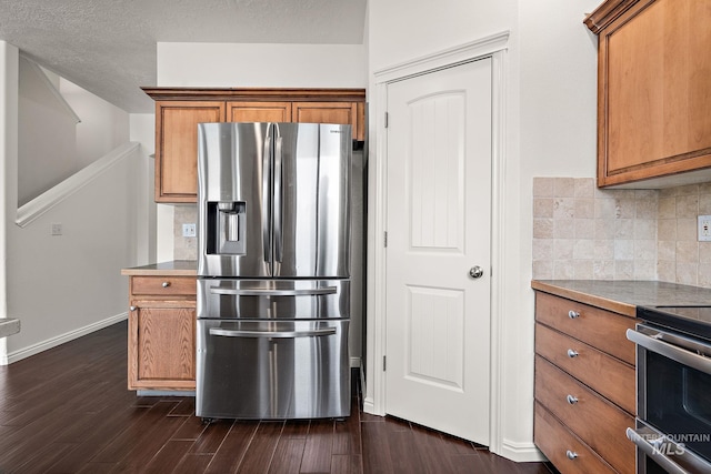 1452 E Pistioa, Meridian, ID 83642 - kitchen with dark wood finished floors, backsplash, stainless steel appliances, and brown cabinets