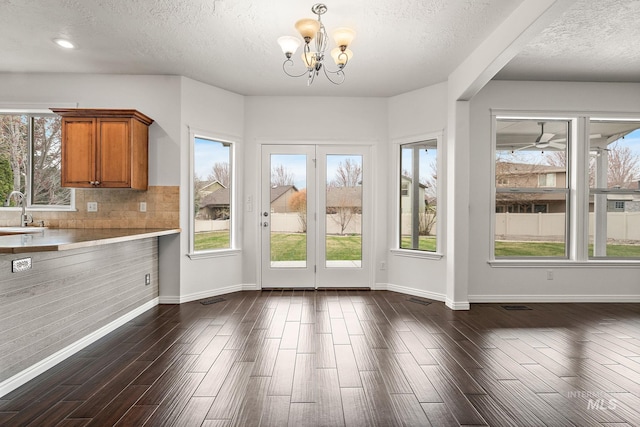 1452 E Pistioa, Meridian, ID 83642 - entryway with an inviting chandelier, a sink, a textured ceiling, baseboards, and dark wood-style floors