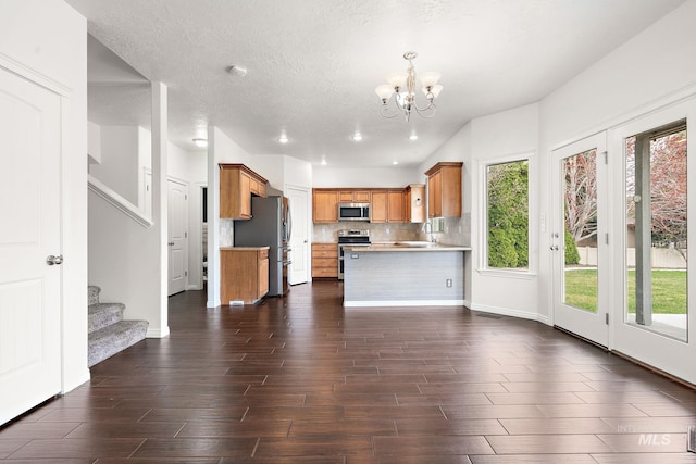 1452 E Pistioa, Meridian, ID 83642 - unfurnished living room with a notable chandelier, plenty of natural light, stairway, and dark wood-type flooring