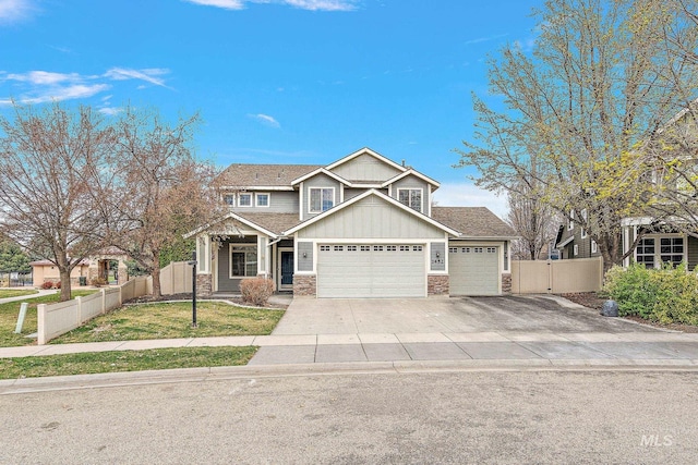1452 E Pistioa, Meridian, ID 83642 - view of front of house featuring fence, stone siding, a garage, board and batten siding, and driveway