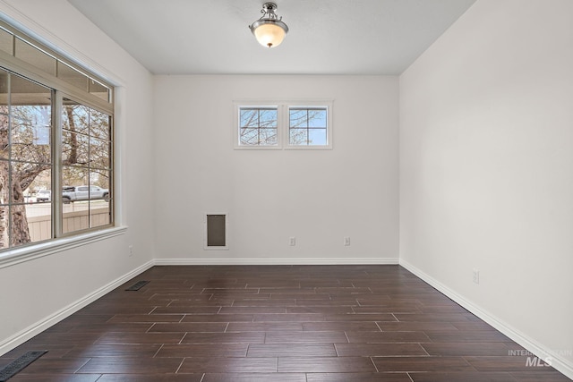 1452 E Pistioa, Meridian, ID 83642 - unfurnished room featuring dark wood-type flooring, baseboards, and visible vents