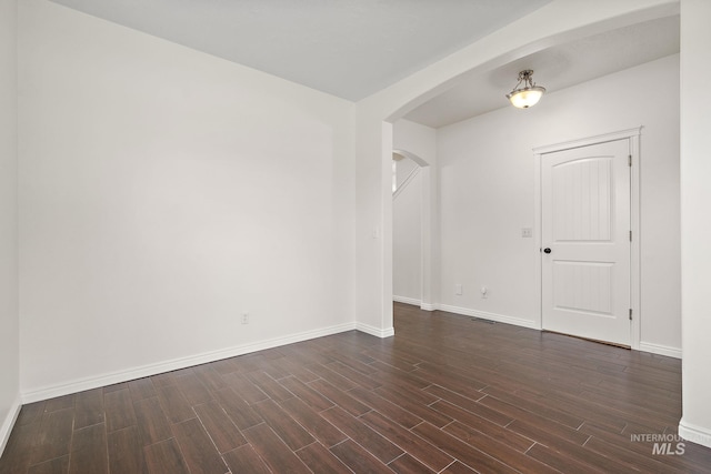 1452 E Pistioa, Meridian, ID 83642 - spare room featuring baseboards, arched walkways, dark wood-style flooring, and visible vents