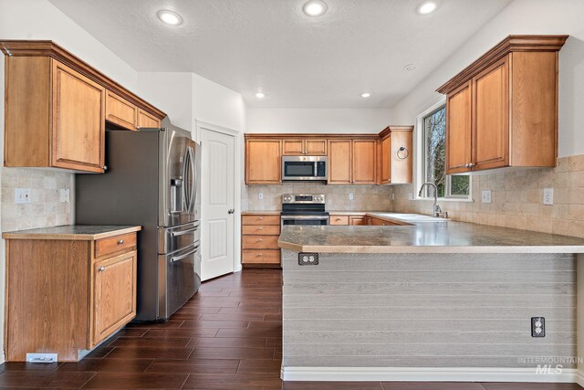 1452 E Pistioa, Meridian, ID 83642 - kitchen with a sink, dark wood finished floors, stainless steel appliances, recessed lighting, and a peninsula