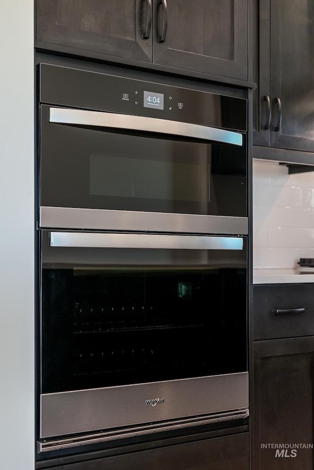 8709 W Pickett Creek St, Star, ID 83669 - kitchen view of double oven, dark brown cabinets, light countertops, and decorative backsplash