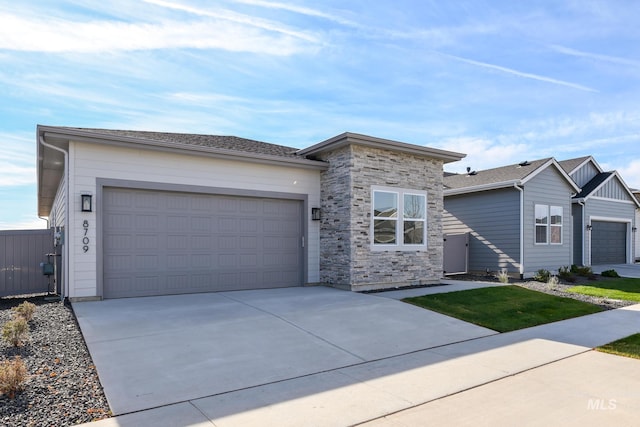 8709 W Pickett Creek St, Star, ID 83669 - view of front of property featuring concrete driveway, an attached garage, and stone siding