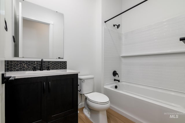 8709 W Pickett Creek St, Star, ID 83669 - bathroom featuring shower / bath combination, vanity, decorative backsplash, and wood finished floors