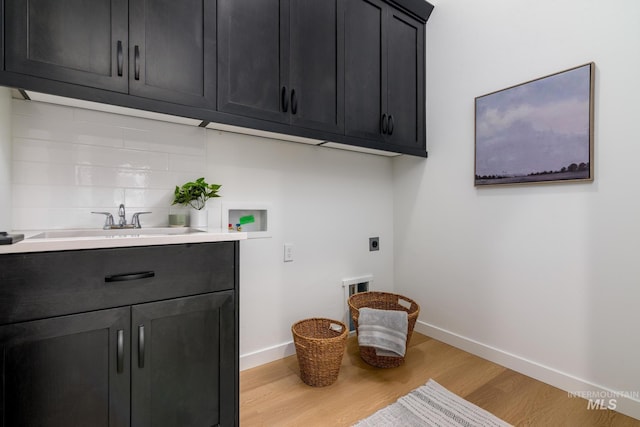8709 W Pickett Creek St, Star, ID 83669 - laundry area featuring electric dryer hookup, light wood-style floors, hookup for a washing machine, and cabinet space