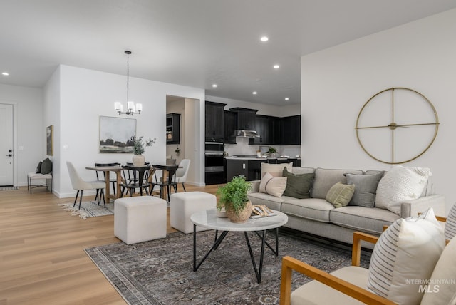 8709 W Pickett Creek St, Star, ID 83669 - living room featuring light wood-type flooring, recessed lighting, and a chandelier