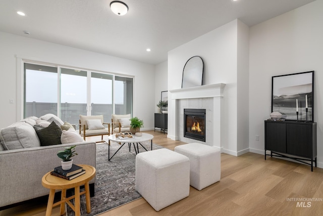 8709 W Pickett Creek St, Star, ID 83669 - living room featuring light wood-style floors, a tile fireplace, and recessed lighting