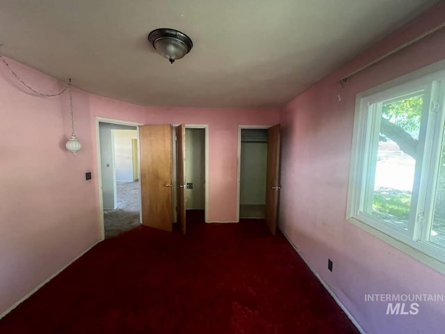 unfurnished bedroom with carpet and a closet