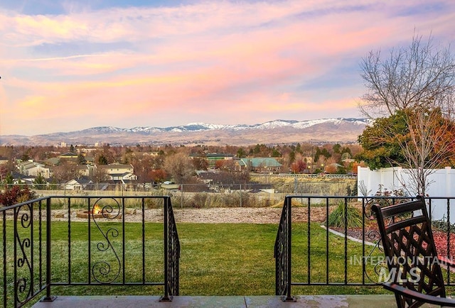 yard at dusk featuring a mountain view