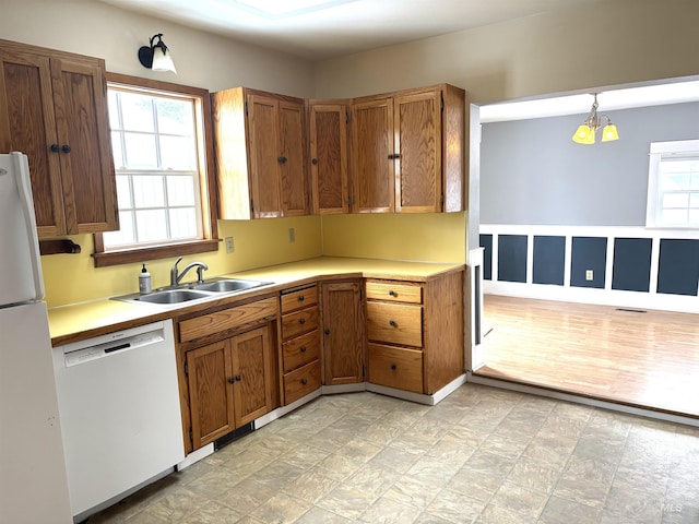 616 E 8th, Moscow, ID 83843 - kitchen with dishwasher, a sink, brown cabinets, and freestanding refrigerator