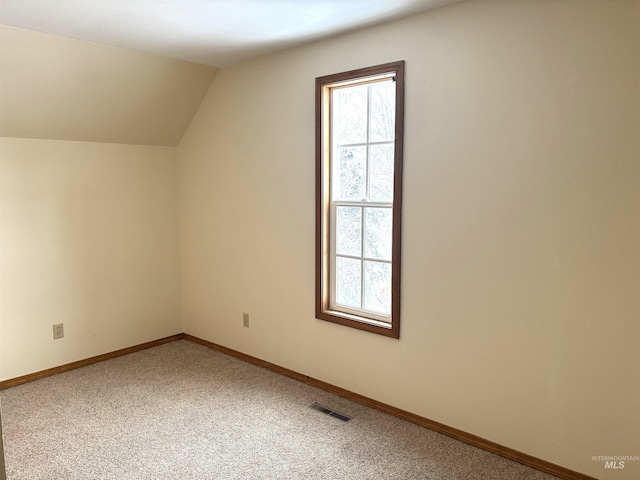 616 E 8th, Moscow, ID 83843 - additional living space featuring plenty of natural light, carpet floors, vaulted ceiling, and baseboards