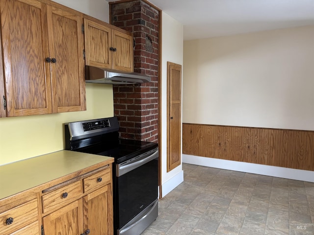 616 E 8th, Moscow, ID 83843 - kitchen featuring stainless steel electric range oven, under cabinet range hood, light countertops, and brown cabinets