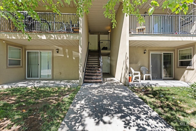 9200 W Brogan Dr Unit A & B, Boise, ID 83709 - view of exterior entry featuring a balcony, stucco siding, and a patio