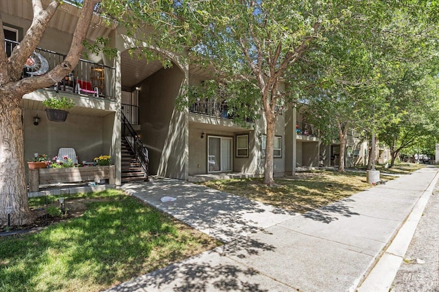 9200 W Brogan Dr Unit A & B, Boise, ID 83709 - view of front facade with stairs, a balcony, and stucco siding