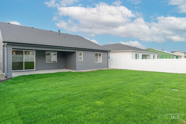 rear view of property with a lawn and a patio area