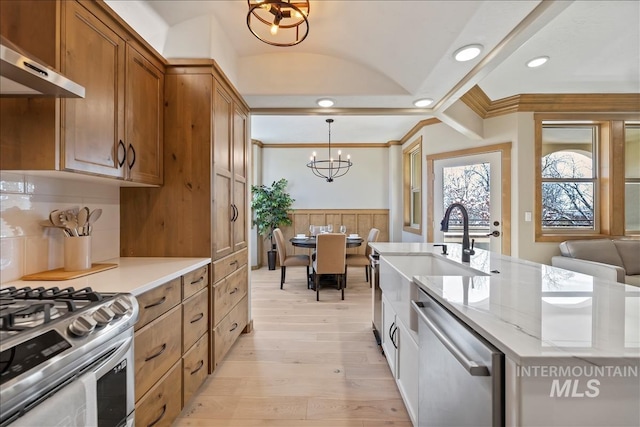 79 E Aikens Rd, Apt Eagle, ID 83616 - kitchen with appliances with stainless steel finishes, extractor fan, a chandelier, wainscoting, and crown molding