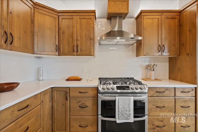 79 E Aikens Rd, Apt Eagle, ID 83616 - kitchen with range with two ovens, brown cabinetry, wall chimney range hood, and backsplash