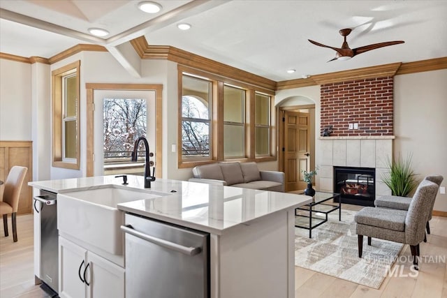 79 E Aikens Rd, Apt Eagle, ID 83616 - kitchen featuring stainless steel dishwasher, open floor plan, crown molding, a ceiling fan, and light stone counters