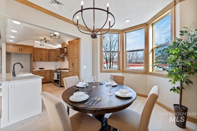 79 E Aikens Rd, Apt Eagle, ID 83616 - dining space with light wood-style flooring, a chandelier, and recessed lighting