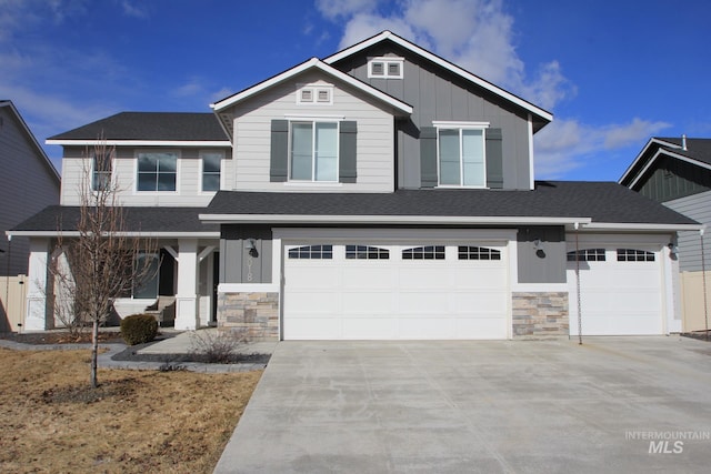 craftsman-style house with board and batten siding, stone siding, covered porch, and driveway