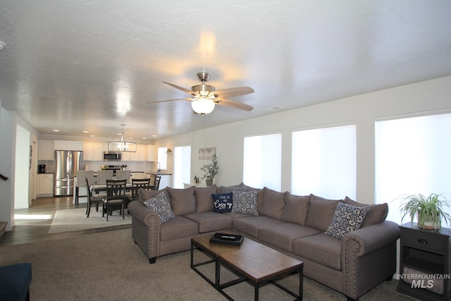 living area with a ceiling fan and recessed lighting