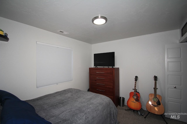 carpeted bedroom featuring visible vents