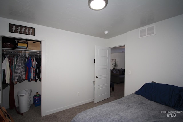 bedroom featuring carpet floors, a closet, visible vents, and baseboards