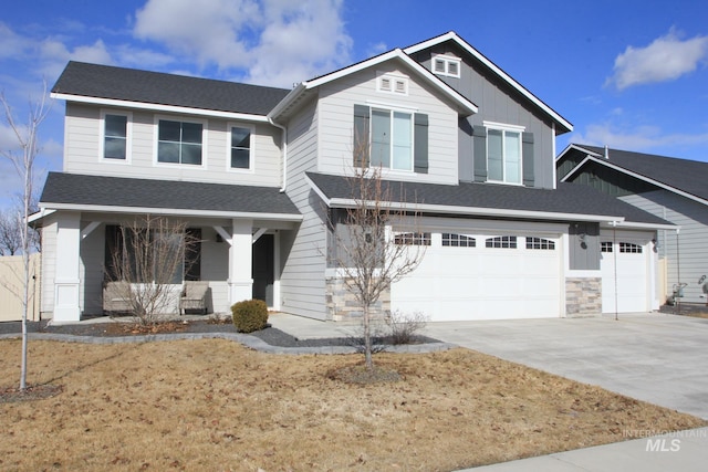 craftsman-style home featuring an attached garage, covered porch, concrete driveway, and roof with shingles