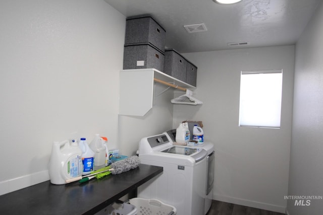 laundry area with laundry area, visible vents, baseboards, and separate washer and dryer