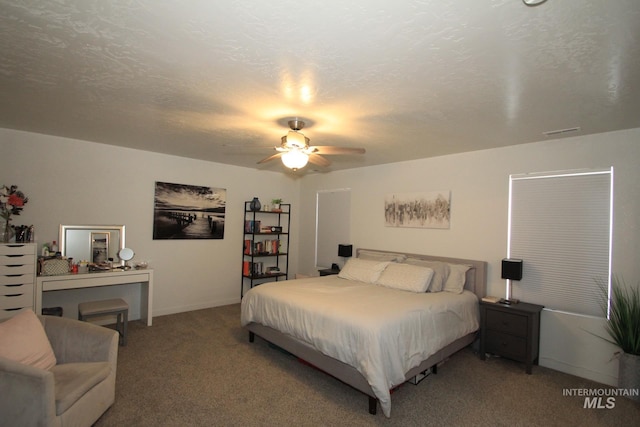 bedroom featuring a ceiling fan, a textured ceiling, visible vents, and carpet flooring