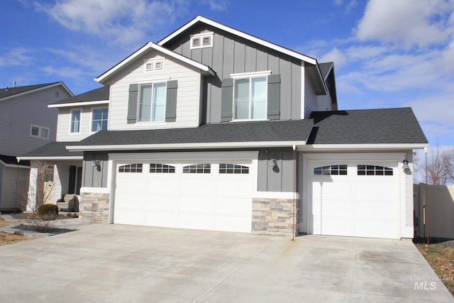 craftsman house featuring board and batten siding, concrete driveway, and a shingled roof